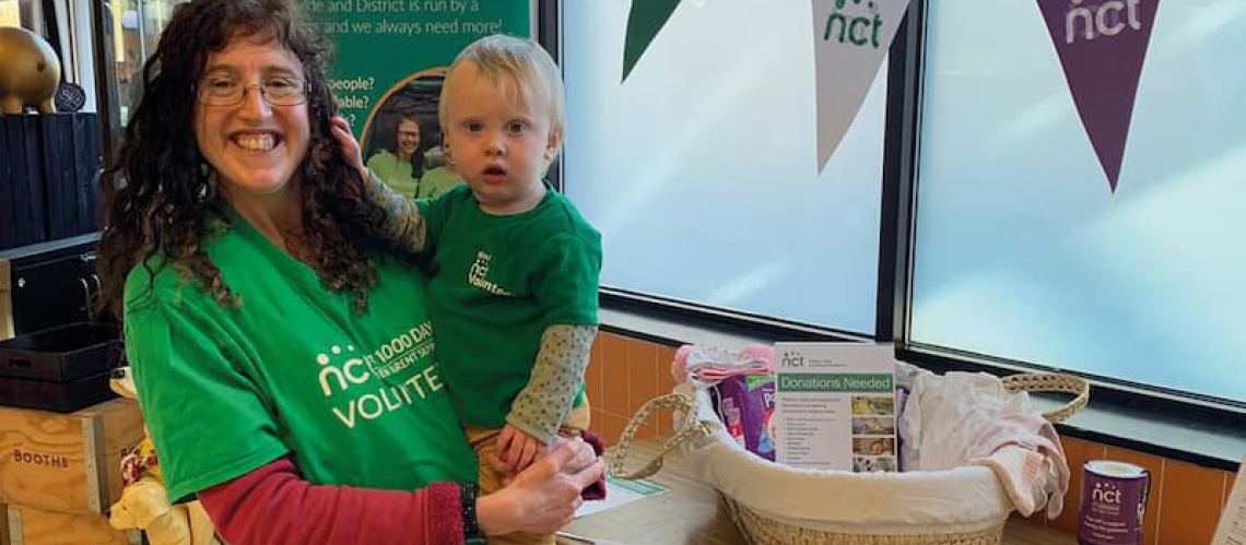 Volunteer with their child at a NCT event